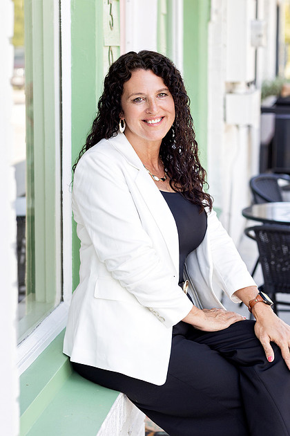 Female real estate agent seated during professional branding session in McKinney